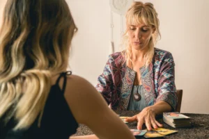 Psychic using tarot cards to interpret energy during a reading.